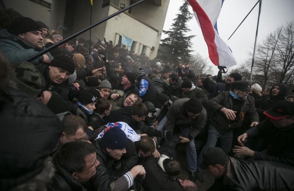 Russian soldiers clash with protesters near the parliament building in Simferopol, Crimea.
