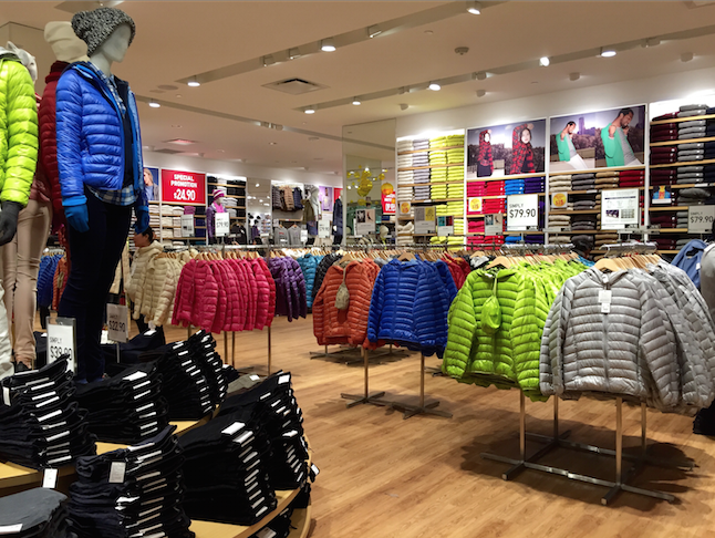 Uniqlo organizes its clothes in color and style arrangement. 