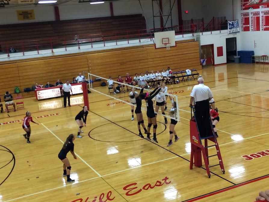 East vs. Washington Township in an intense volleyball game. 