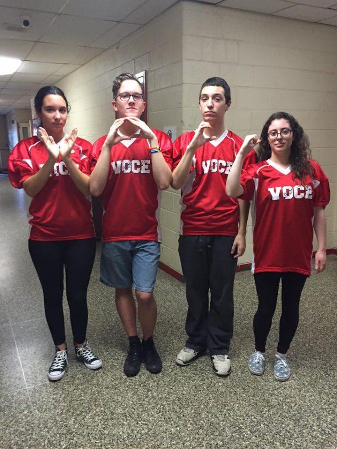 Voce members proudly represent their group with a clear-cut VOCE hand formation. 