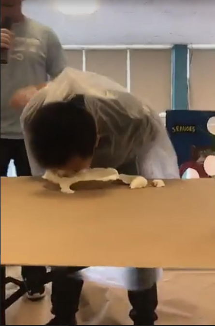 Sophomore Calvin Chan (19) stuffs his face with pie, as he searches for the candy hidden within it. 