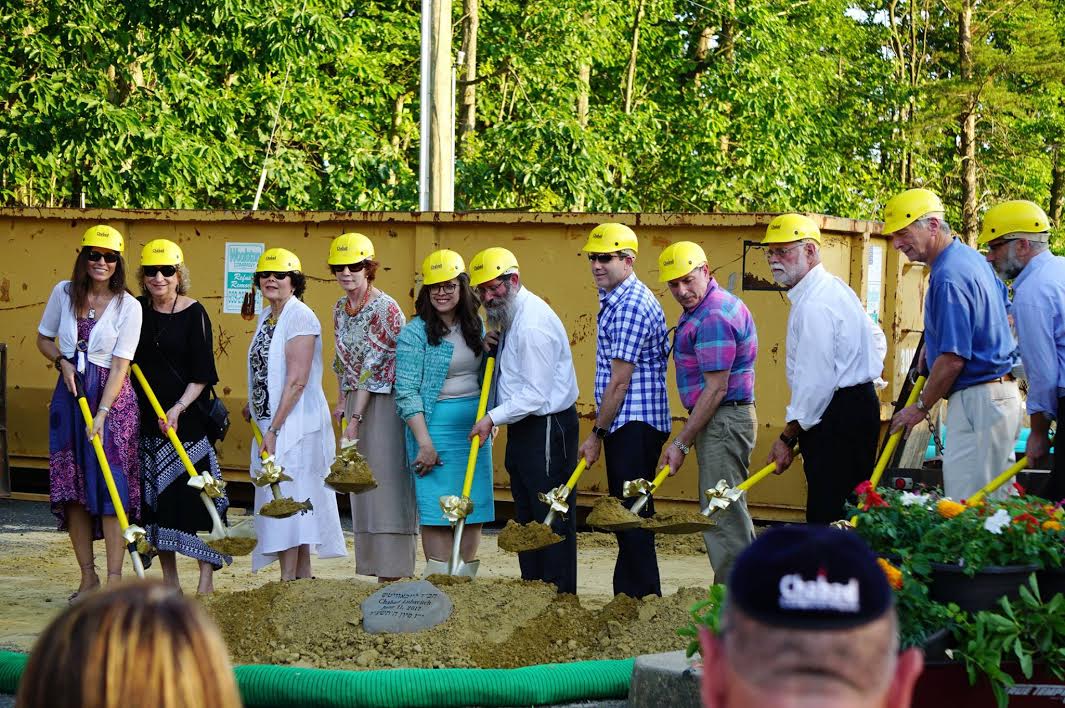 Members of the Chabad community begin the groundbreaking ceremony