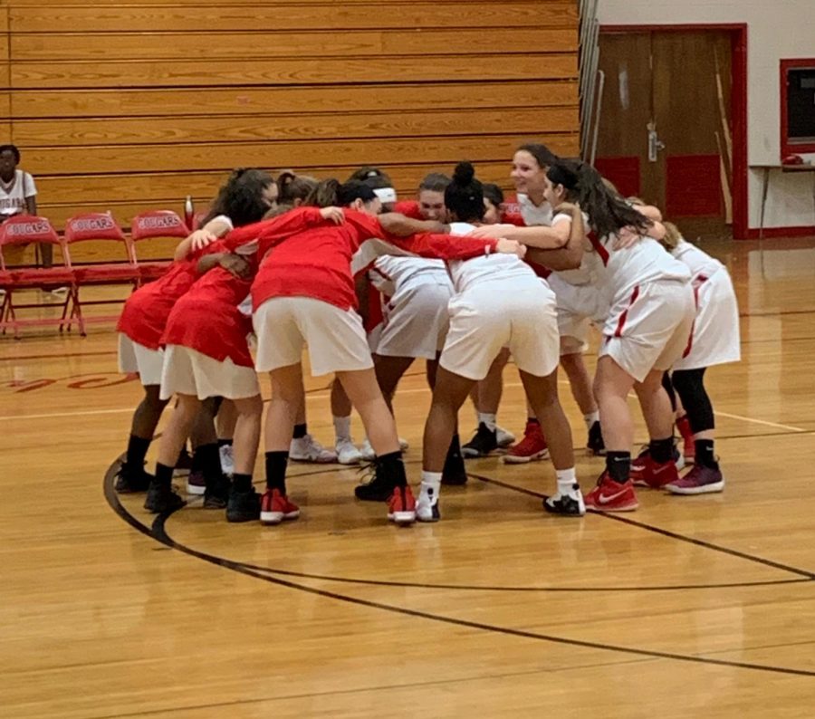 The East Girls Basketball players huddle before the game. 