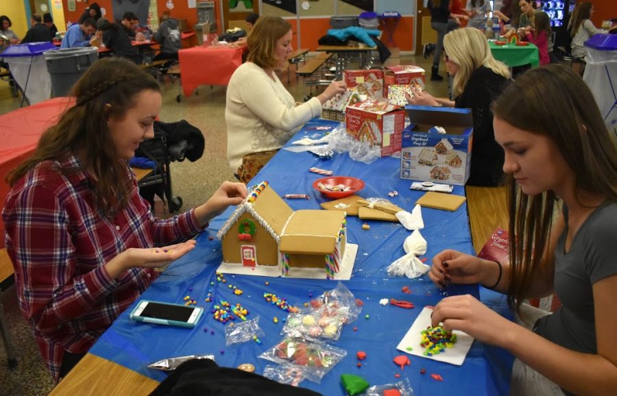 Students from Habitat for Humanity participate in a gingerbread house making activity.