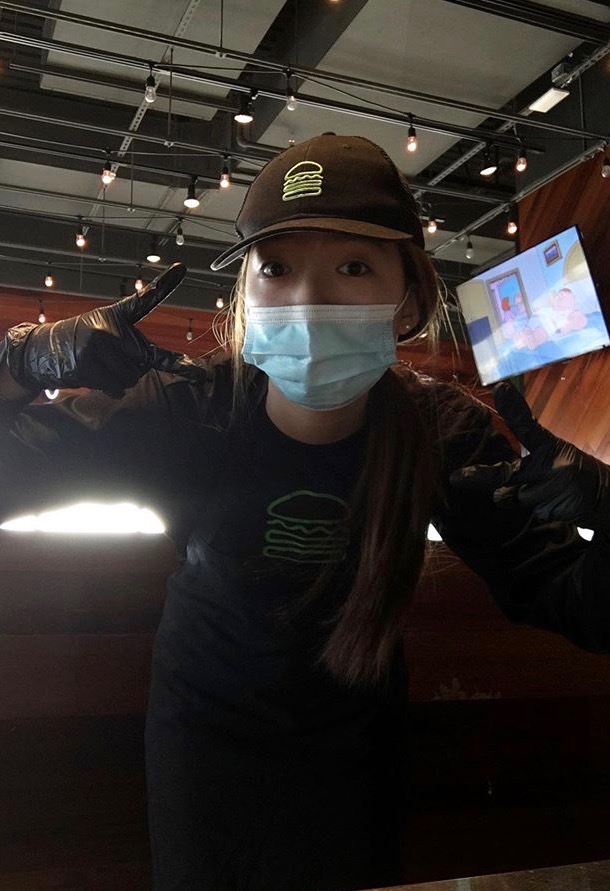 Jiseon Lee (20) poses with a mask while at work.