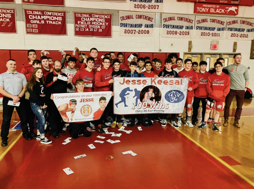 Jesse Keesal (‘20) and his team celebrate his 100 wins.  