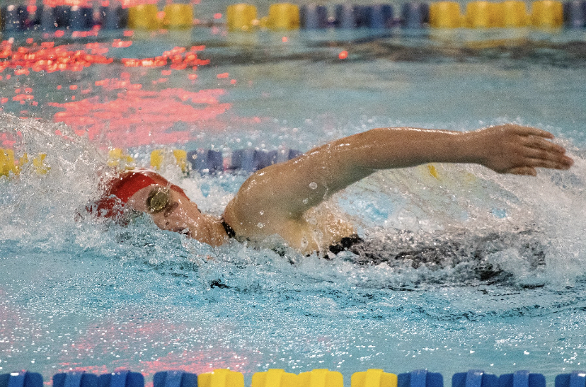 Annie Behm (‘21) swims her way to victory at a meet for East in the backstroke.