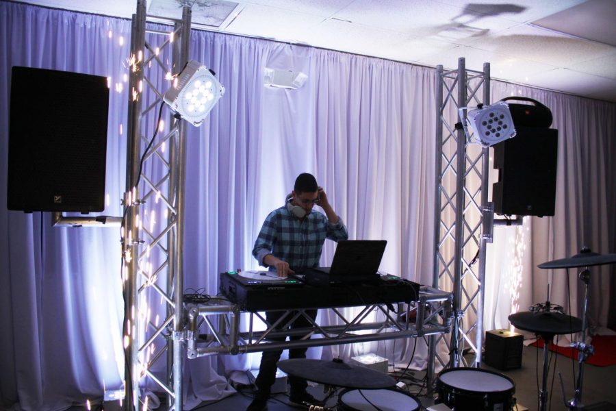 Bloom sets up his equipment for an event he was hired to DJ. 
