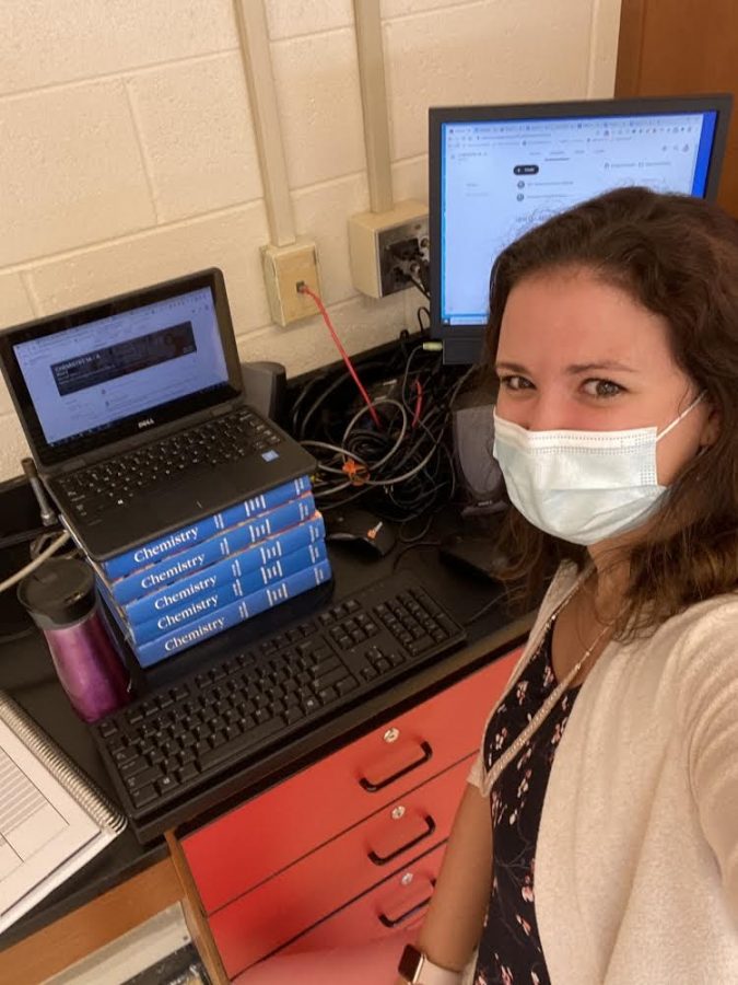 Mrs. Pereira takes a selfie of her virtual work station. 