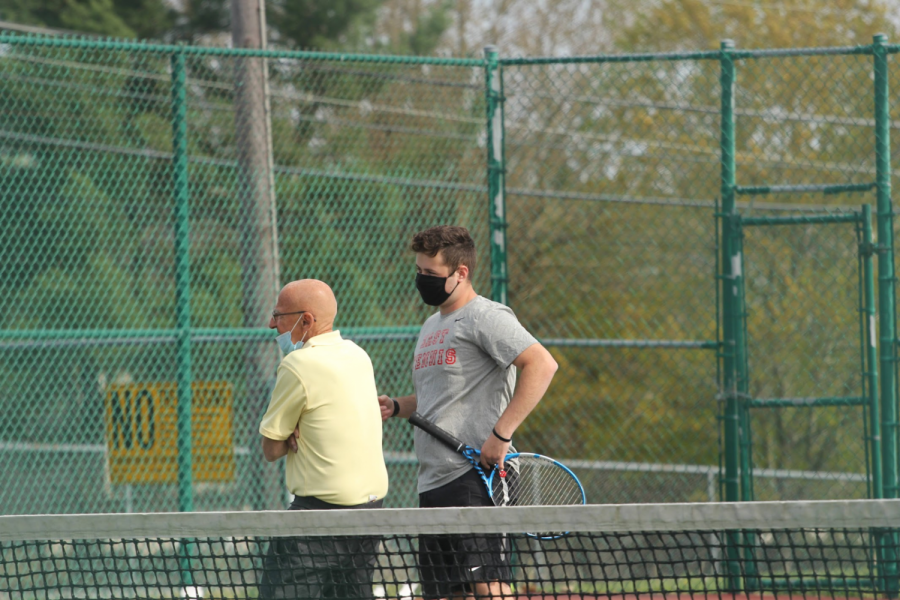 Senior Jacob Pasternack speaks with the referee after his doubles victory with Matt Dickinson (‘21)  against Cherokee.