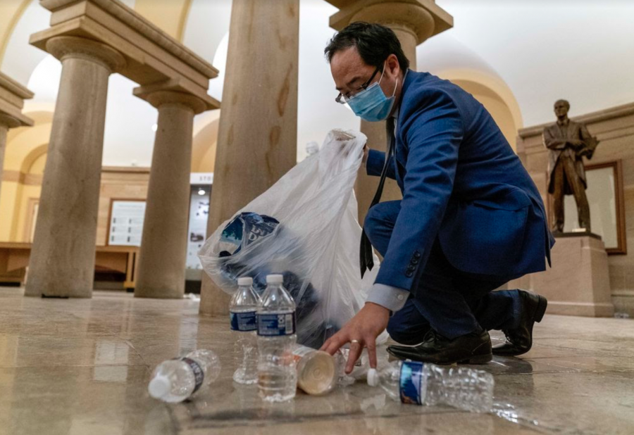 Rep. Kim cleans up debris and trash on the floor of the Capitol after the Capitol Insurrection, an act that brought him national attention.