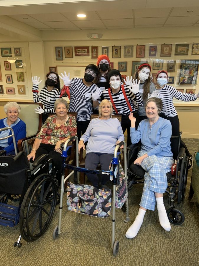 The Cherry Hill East Mime Company poses with members of the Lions Gate Retirement Community members at one of their performances