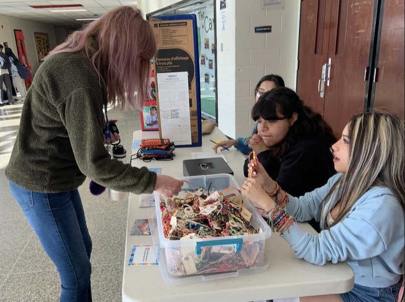 Club members from Spanish Honors Society, Latinos and Amigos, and Interact sold pulseras and bolsitas in front of the East Auditorium.  