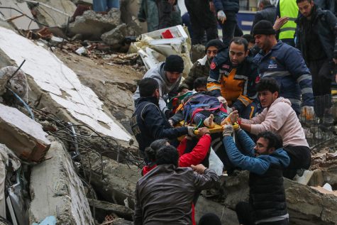 Rescuers recover a child trapped under rubble