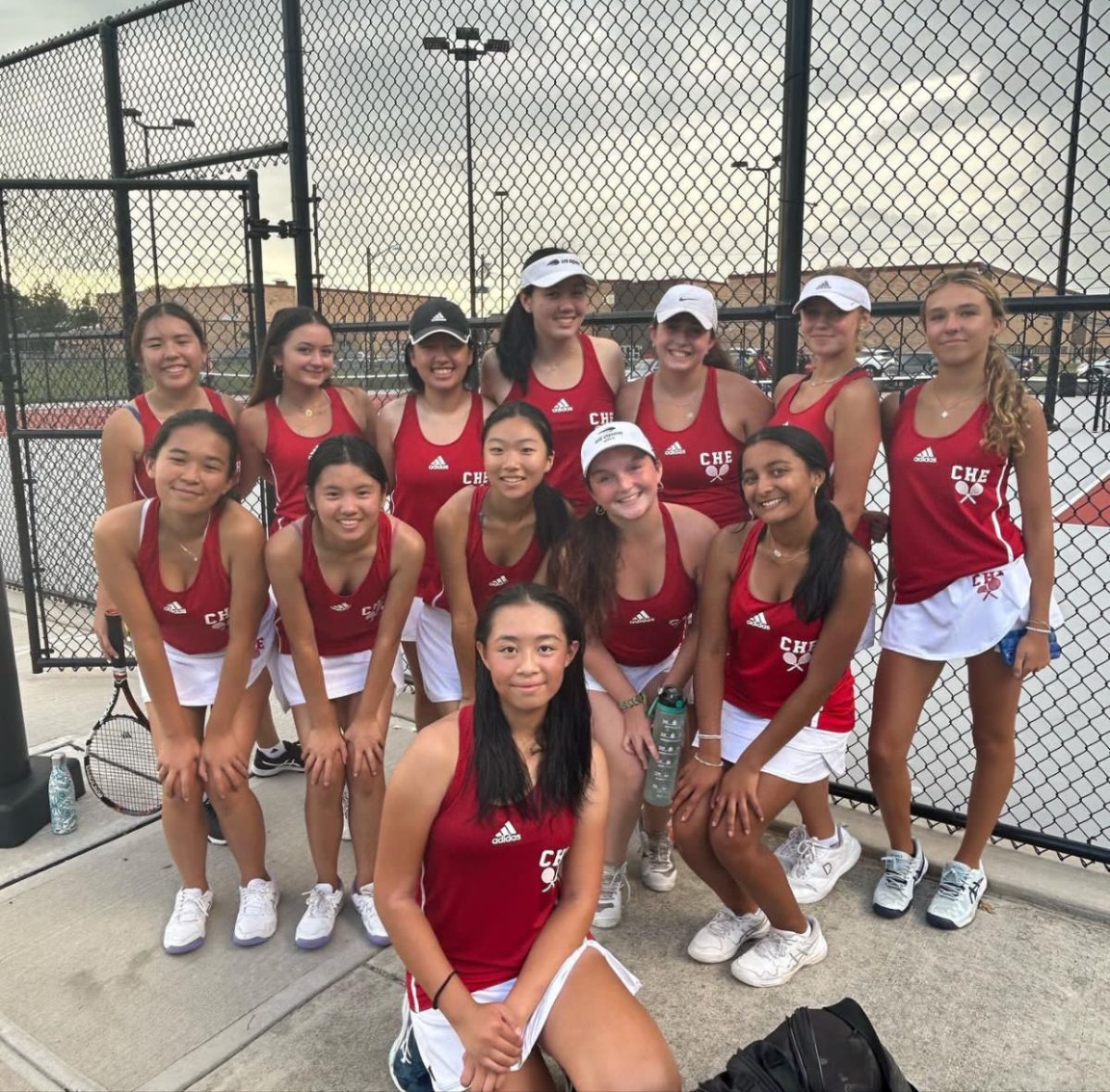 East+girls+tennis+team+poses+for+a+picture+after+their+win+in+the+season+opener.+