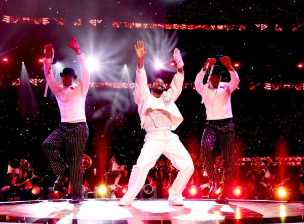 Usher performs at the Super Bowl LVIII halftime show with guest singers and backup dancers. 