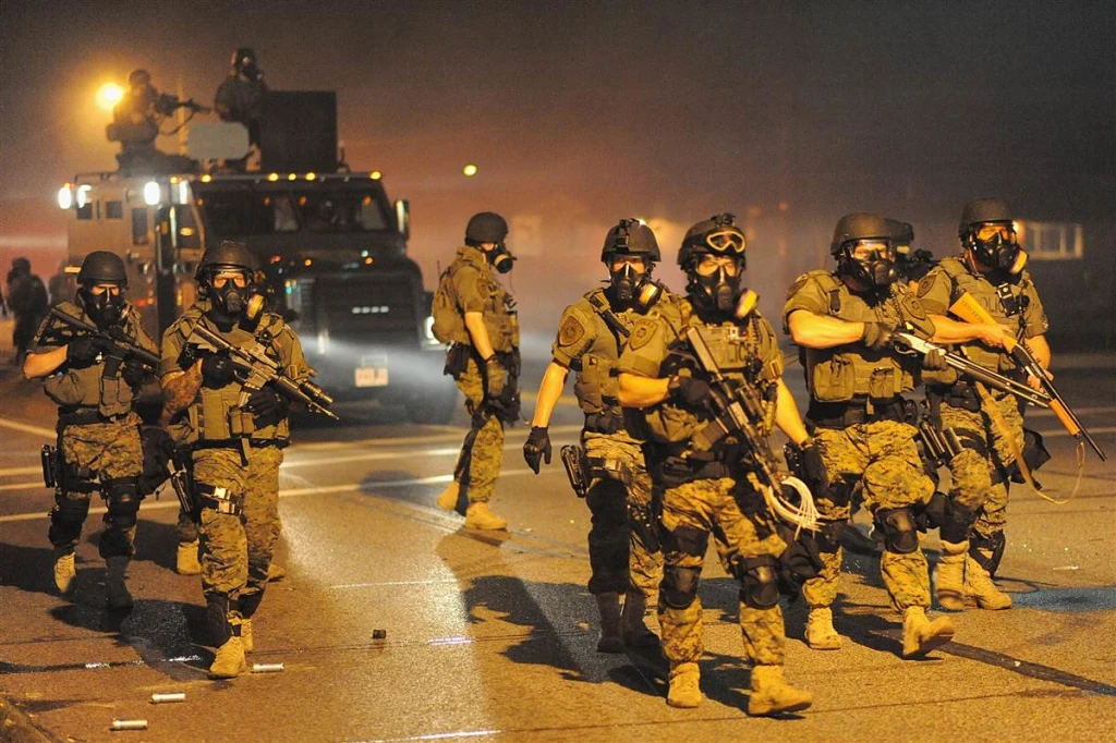 Ferguson, Missouri police move to quell civilians protesting against the death of Michael Brown (Courtesy of Macleans)