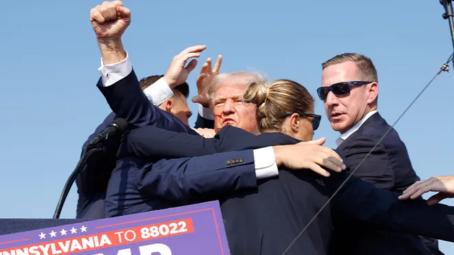 Trump pumping hist fist into the air saying, "Fight. Fight. Fight."