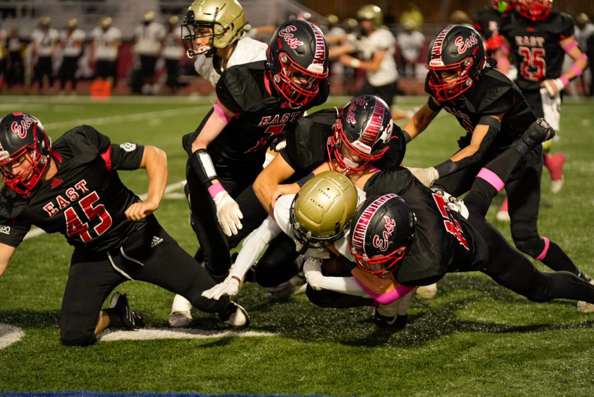 Dog pile including five East players and one Deptford player.