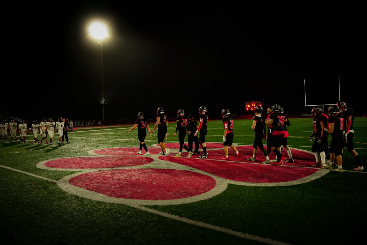 Cougars football team shakes hands with ACIT after their victory.