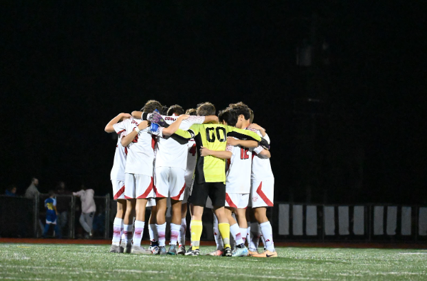 East soccer boys huddle before the start of the game. 