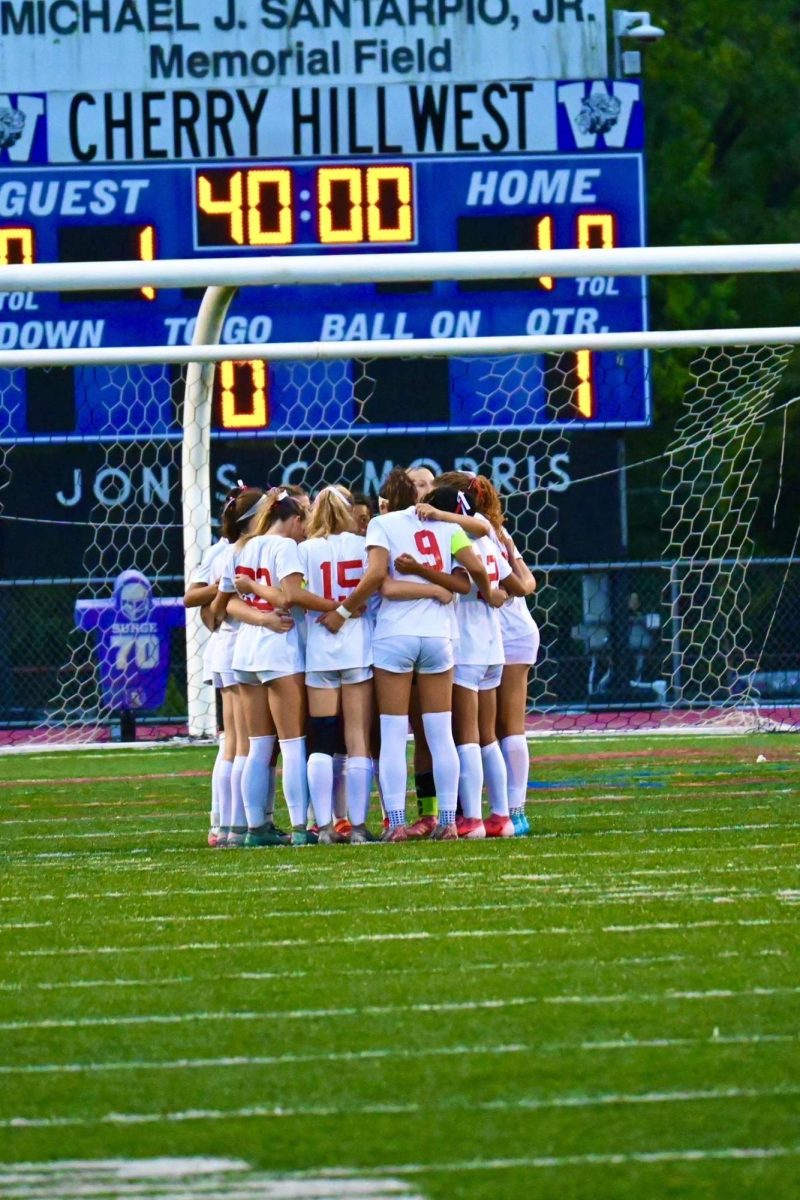 East girls soccer team huddling before the second half begins.