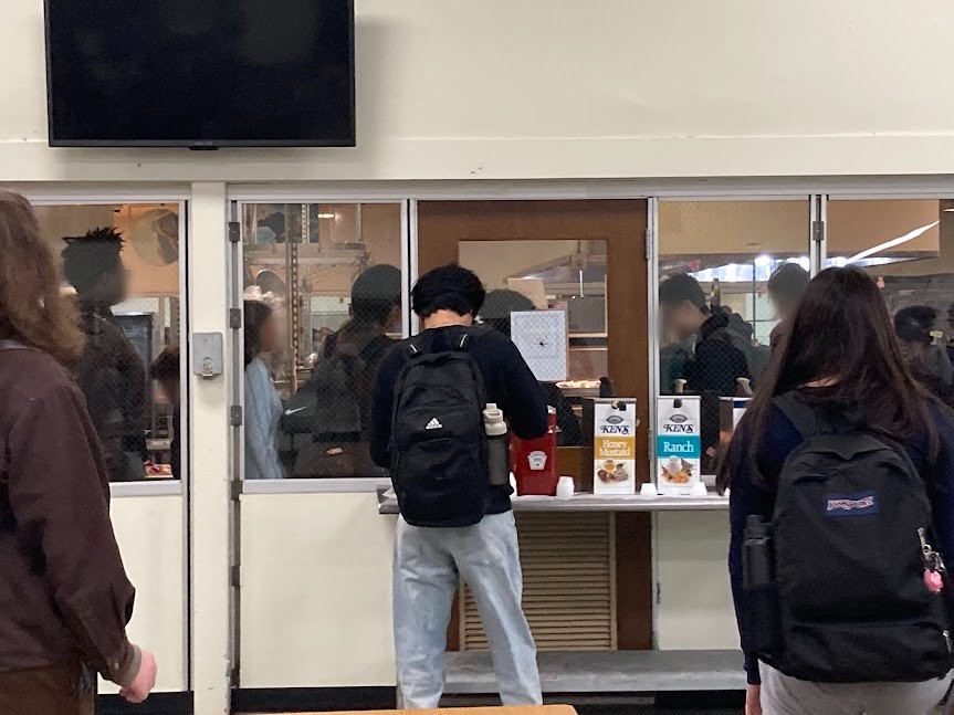 Students wait in the overflowing lunch line at the beginning of LB2