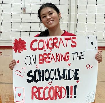 Mon celebrates her impressive athletic feat with the volleyball team. 