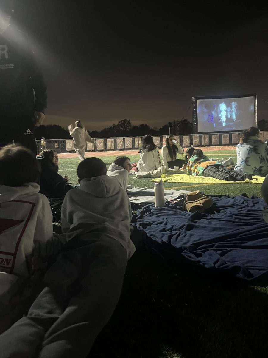 Students and friends enjoying watching the movie during school wide movie night fundraiser.