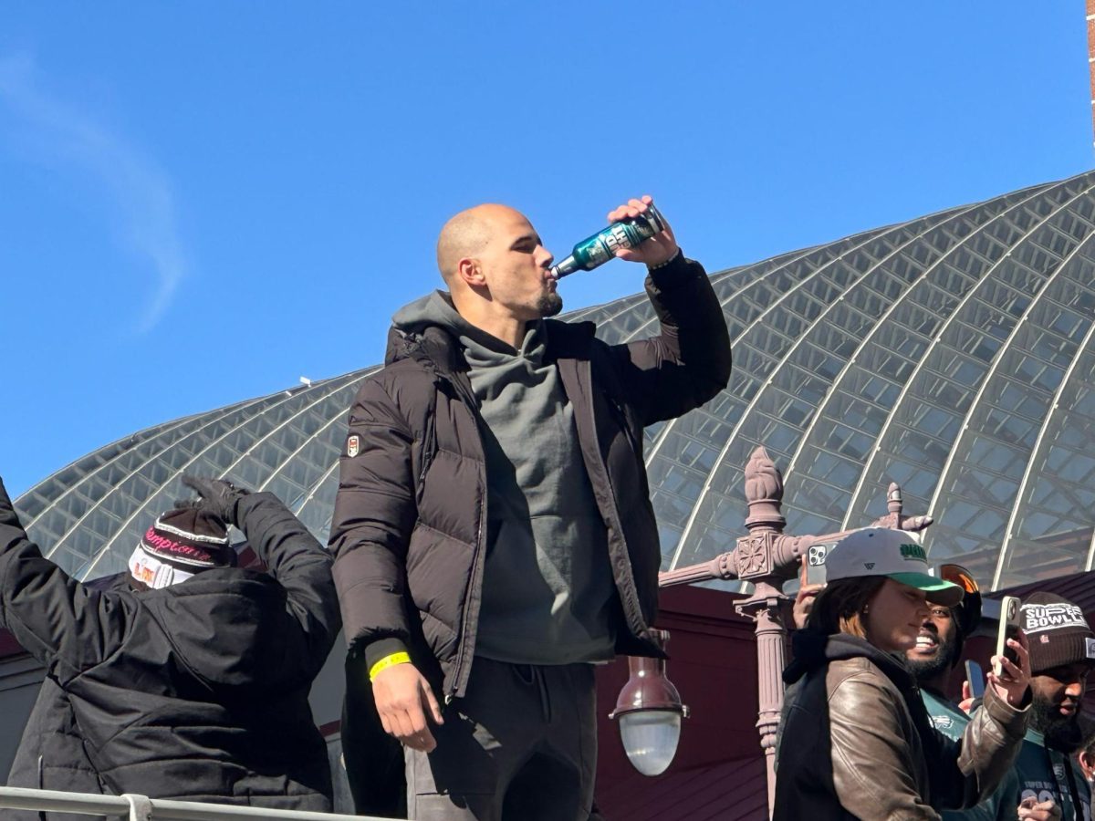 Linebacker Zack Baun drinks a bottle of beer during the Eagles Parade. 