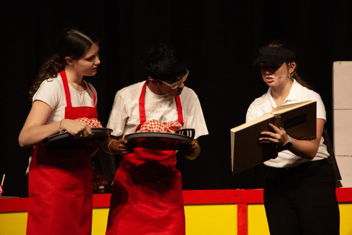 The manager, played by Leah Katz ('28), goes over the rulebook for employees.