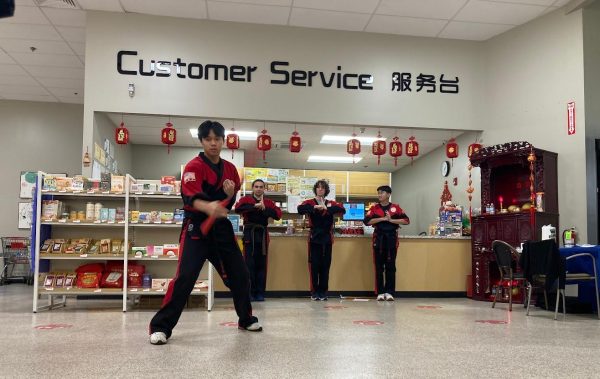 Kempo Family Fitness’s martial arts team demonstrates their routine near the front of Hung Vuong. 