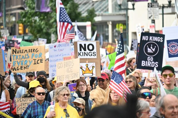 Protesters march down Market Street holding signs with a multitude of messages in protest of President Donald Trump. 