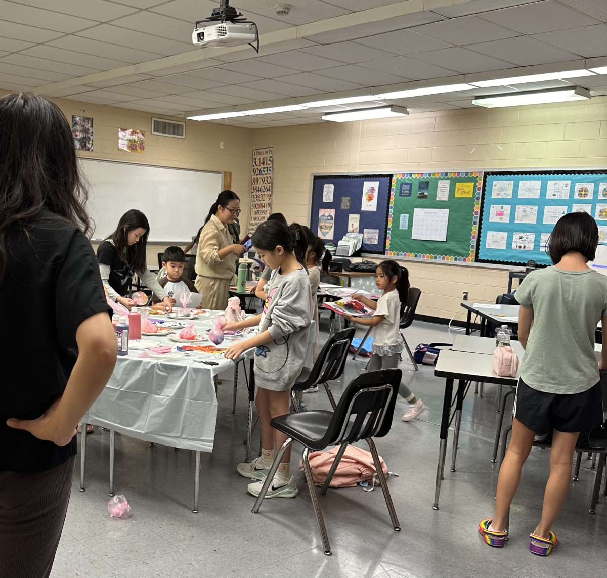 Students in CHHCS's art class work with paint in their projects.