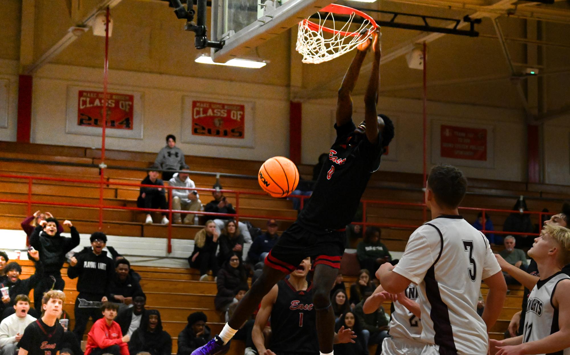 Kristen Glenn (0) hangs on the rim following a powerful dunk. 