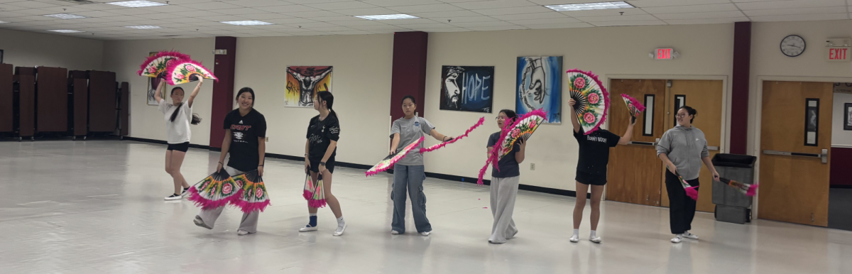 KSSNJ's dance class practices Buchaechum, the traditional Korean fan dance. 