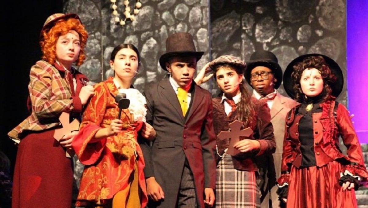 Karina Cowan ('26), Shia Rose Snyder ('26), Lukas Ortega ('26), Zoe Kukafka ('27), Jamiir Rose ('26), and Ali Reddy ('26) portraying their roles of Shirley Holmes, Sabrina Van Helsing, Dr. Van Helsing, Jennie Watson, Jon Harker, and Mina Murray, respectively. 