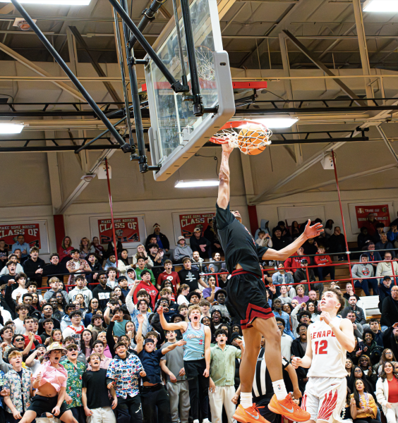 Chris Abreu (2) rises up and throws it down as the crowd roars.