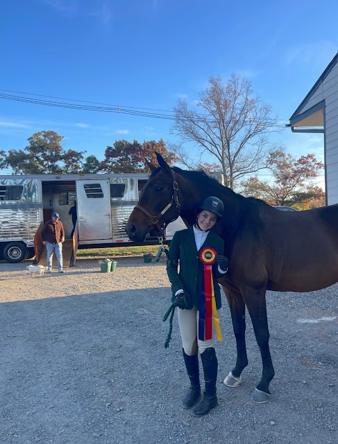 Kleger poses with her horse and ribbon at a competition.

(Courtesy of Sophia Kleger)