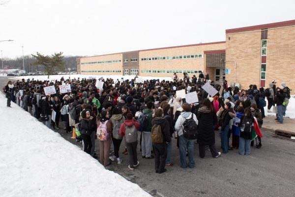 East students walk out from the East Gym to the road in front of the annex. 