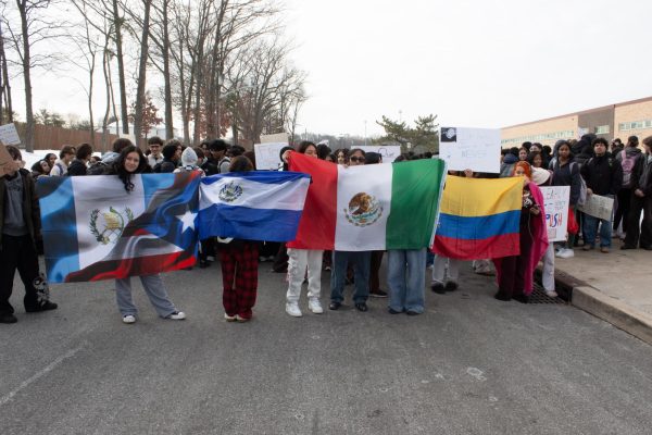 Students show the flags that they brought to the protest. From left to right: The flags of Guatemala and Puerto Rico, El Salvador, Mexico, and Colombia.
