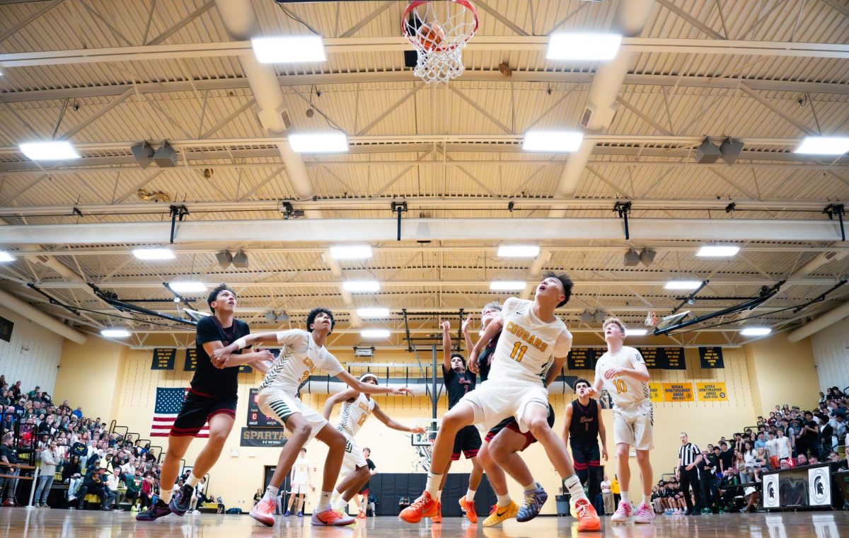 Chris Abreu (2) shoots a free throw as several players crash the bucket for the rebound.