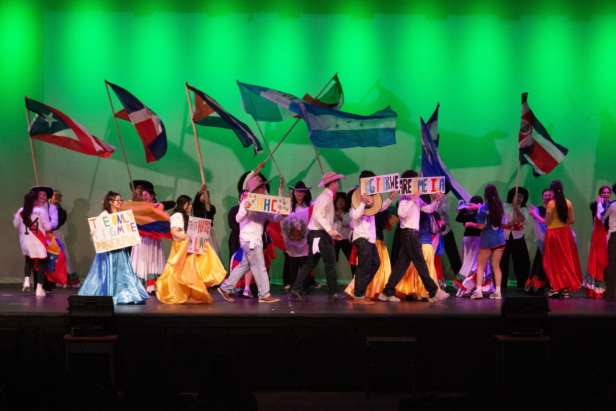 Hispanic Heritage Club (HHC) ends their performance by waving flags from hispanic countries.