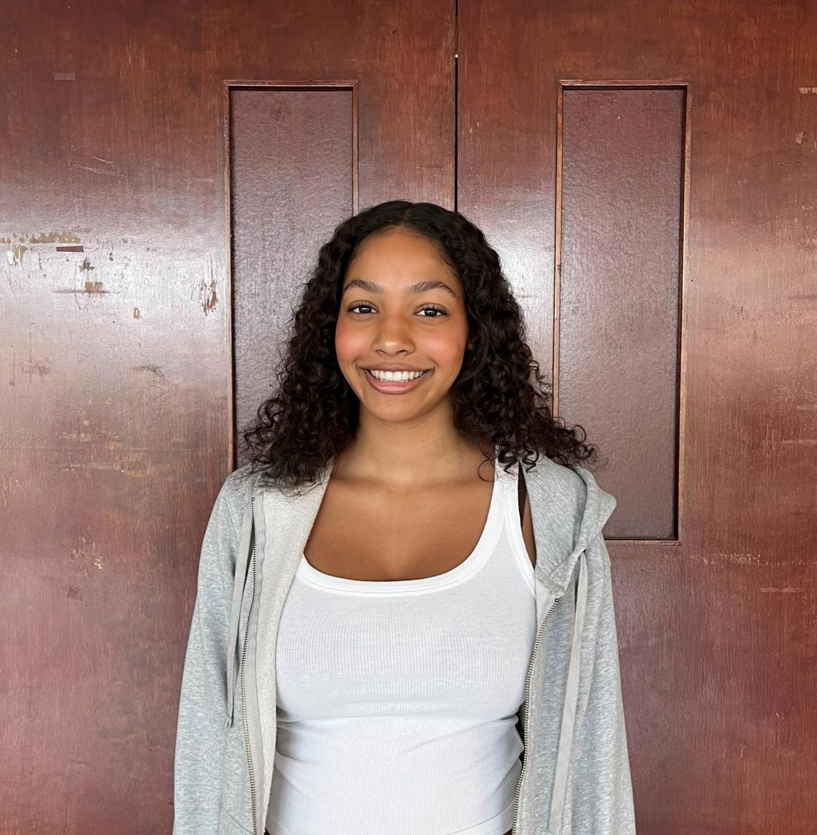 Akira Gordon ('26) poses in front of the auditorium doors. 