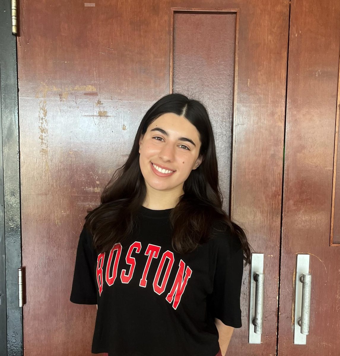 Shia Snyder ('26) poses in front of the auditorium doors. 