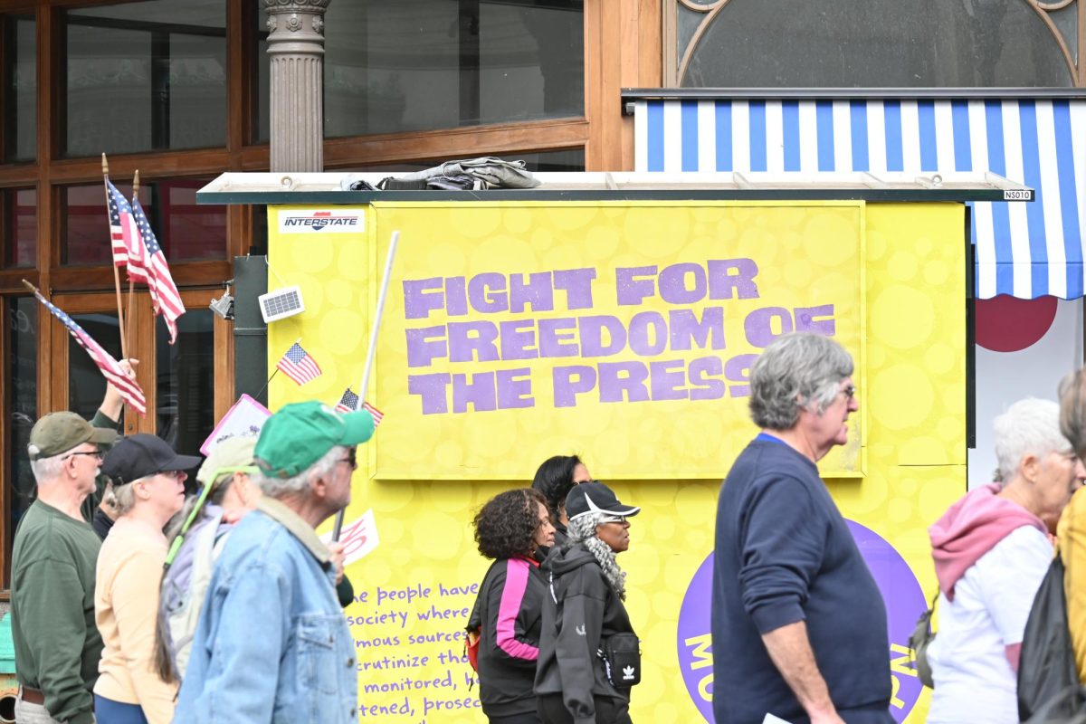 Art on the side of a booth in Philadelphia calls for freedom of the press, a heavily disputed matter. 