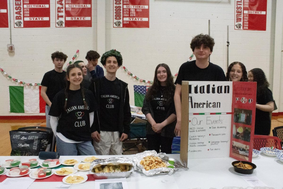 The Italian American Club poses for a photo with their booth members.