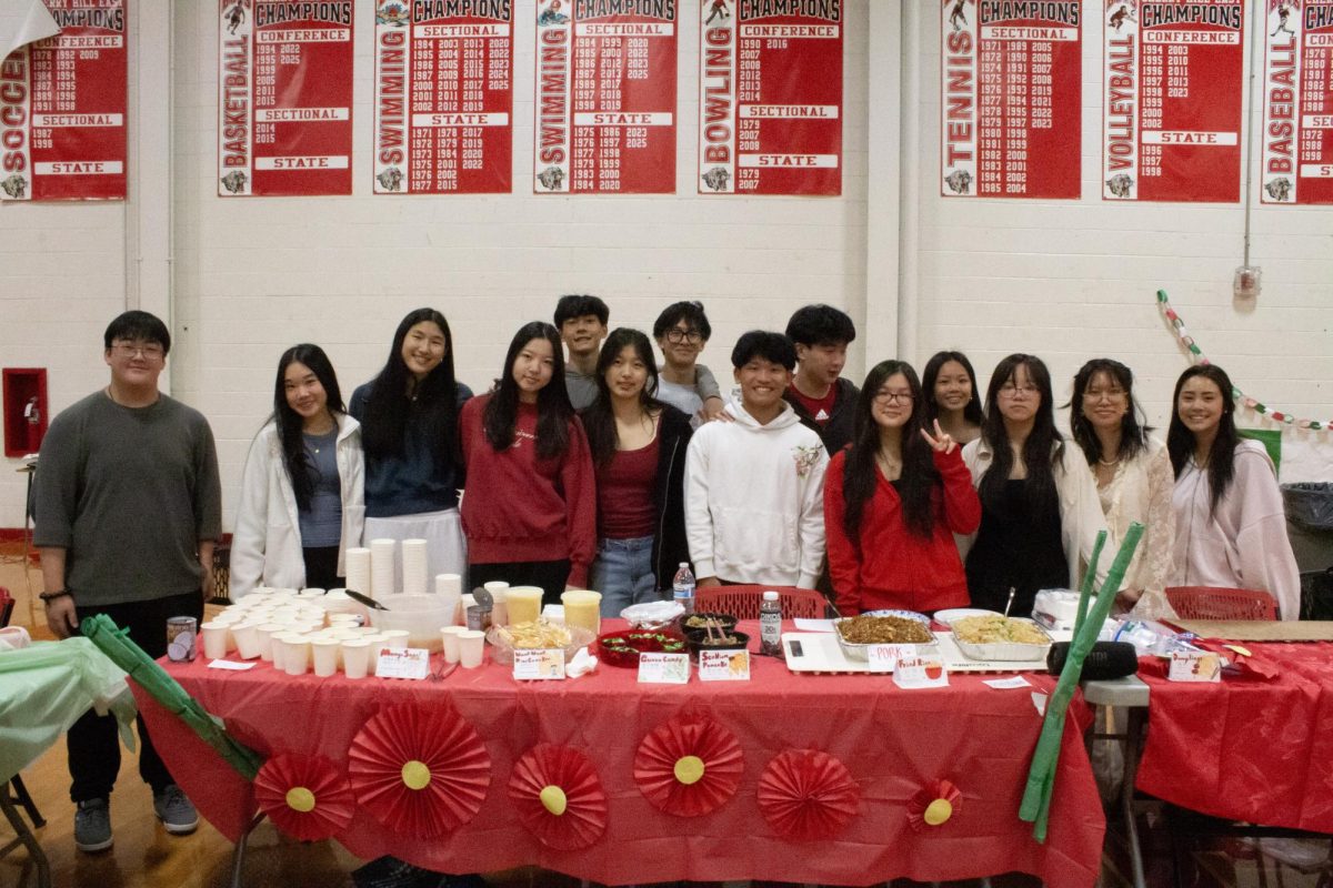 The Chinese Students Association poses for a photo with all of their booth members.