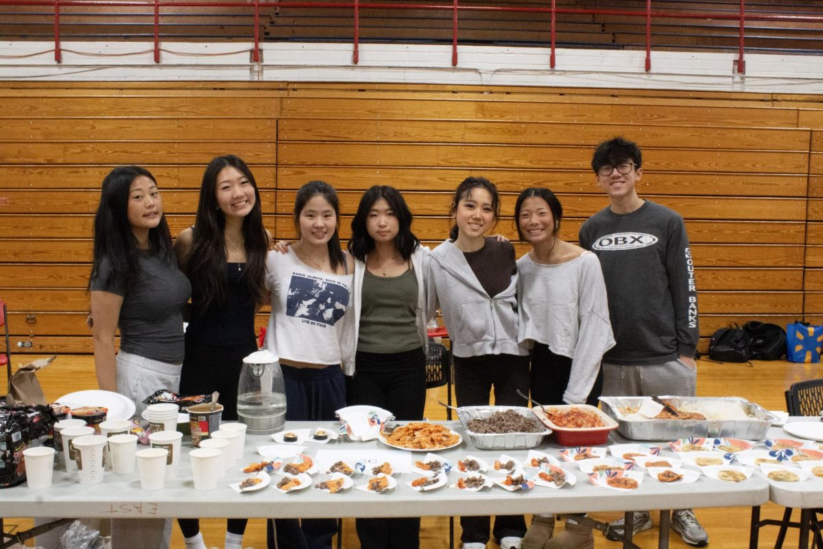 The Korean Culture Club booth members pose for a photo.