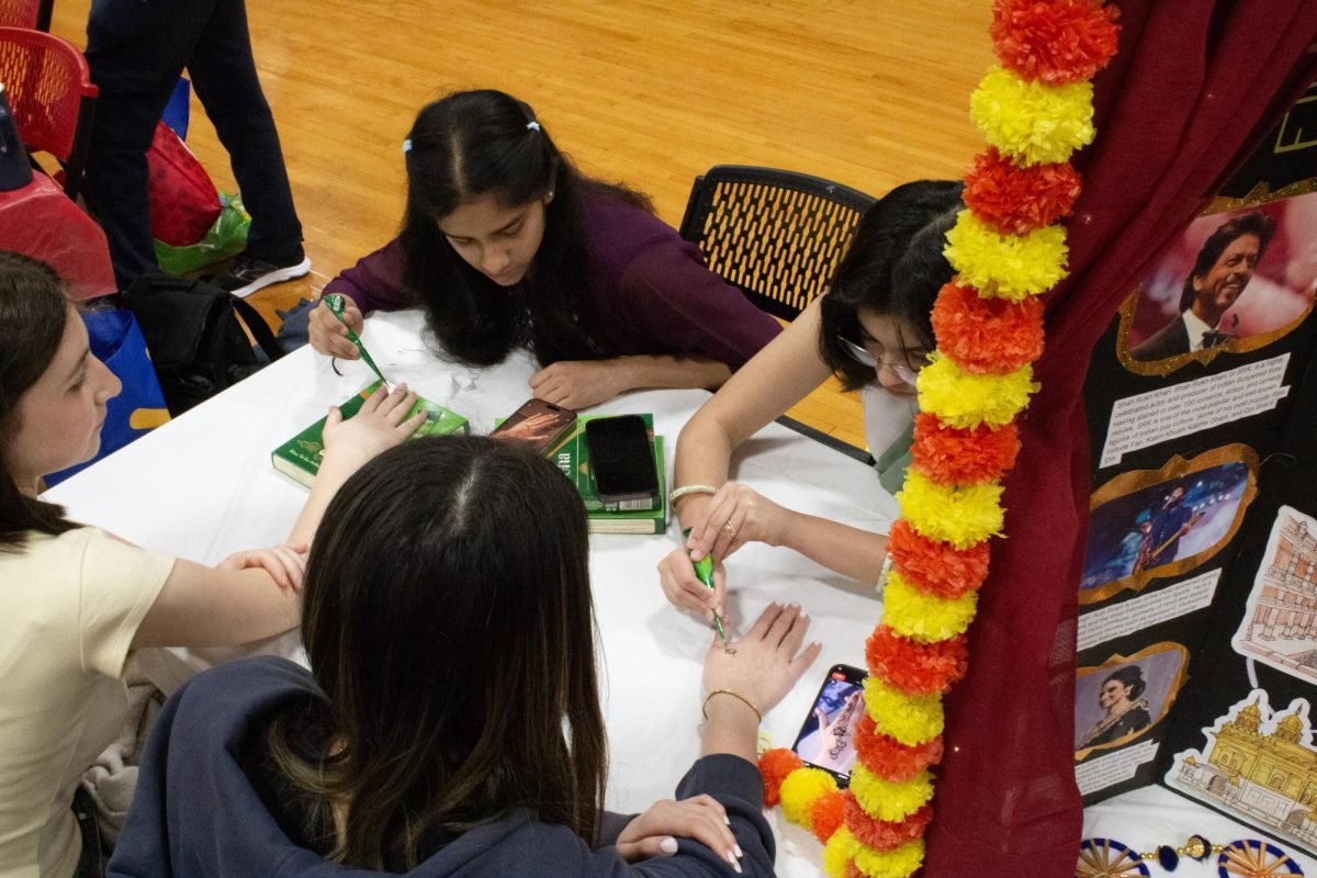 The Indian Cultural Society offers henna for students at their booth.
